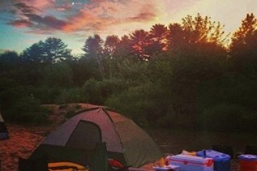 a sunset over a tent